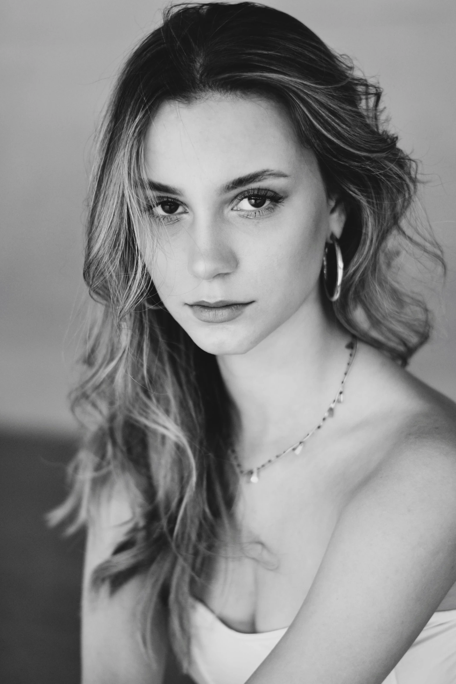 a black and white photo of a woman, inspired by Elizabeth Polunin, photorealism, handsome girl, gorgeous stella maeve magician, girl with a pearl earringl, portrait sophie mudd