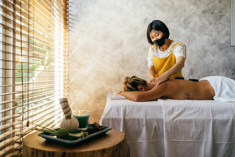 a woman getting a back massage at a spa, pexels contest winner, darren quach, 😭🤮 💔, manuka, covid