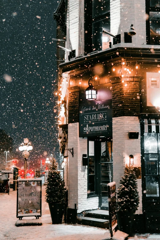 a snow scene with people walking by a building