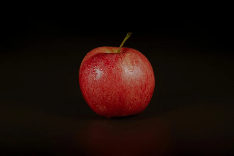 a red apple sitting on top of a table, in front of a black background, high quality product image”, looking towards camera, the photo shows a large