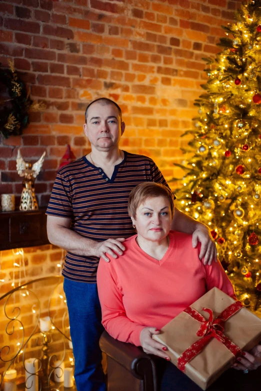 an older man with his arm around a woman's shoulders and presents tied to their backs