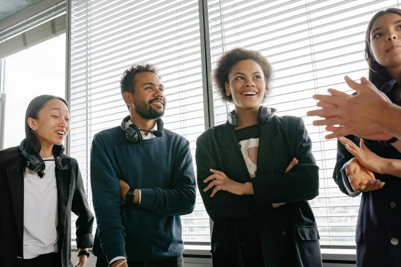 a group of people standing next to each other, in an office, profile image, laughing, varying ethnicities