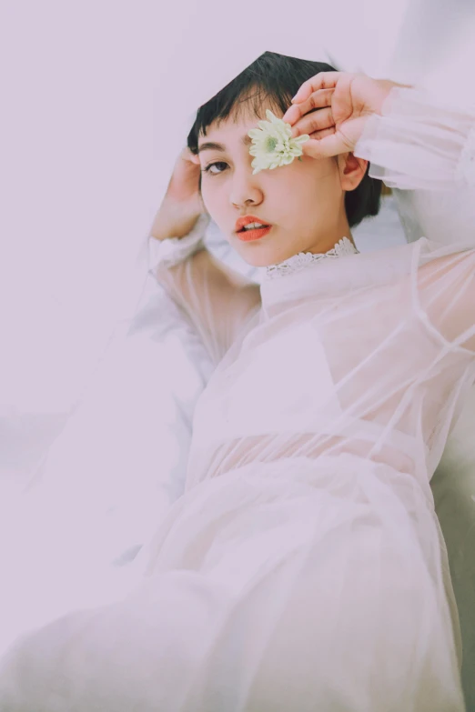 a woman in a white dress laying on a bed, an album cover, inspired by Ren Hang, unsplash, kiko mizuhara, see - through, guweiz, white sleeves