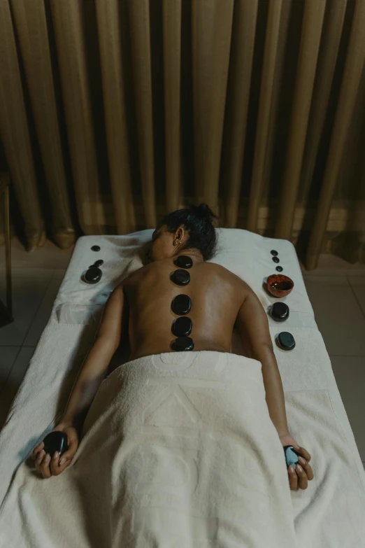 a man getting a back massage at a spa, a charcoal drawing, by Adam Marczyński, pexels contest winner, with piles of coins around it, asian woman, gif, black opals