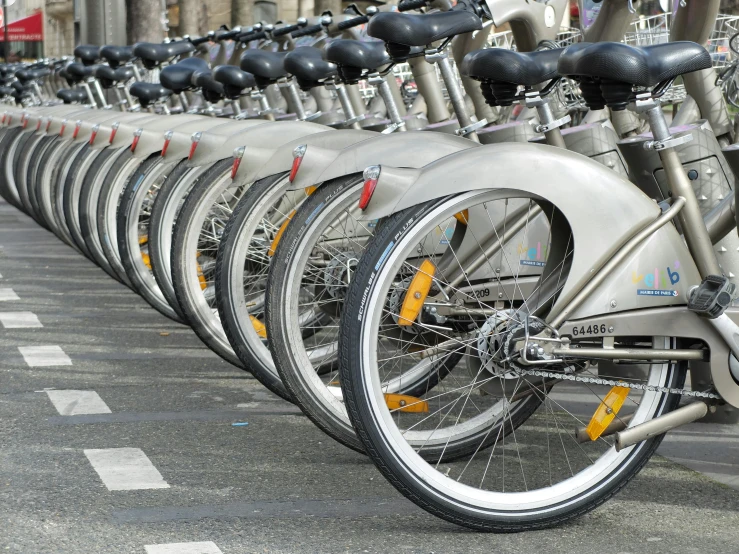 a row of bicycles parked next to each other, pexels contest winner, happening, avatar image, shiny silver, 2040, circular