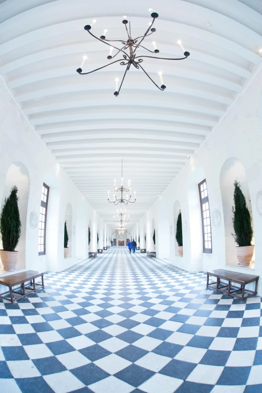a room with large checkered tile floors and white walls