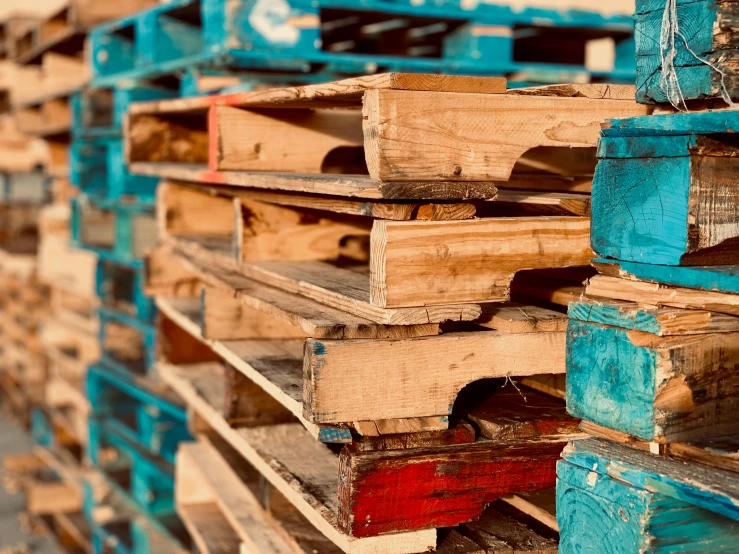 a stack of wooden pallets stacked on top of each other, by Daniel Lieske, unsplash, assemblage, brown and cyan blue color scheme, thumbnail, mining, full of colour