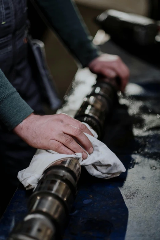 a close up of a person working on a machine, dirty linen robes, crying engine, sleek hands, swanland