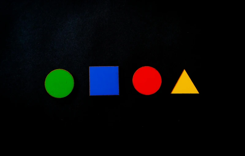 a group of different colored shapes on a black background, trending on unsplash, bauhaus, 15081959 21121991 01012000 4k, colorful signs, wooden art toys, green blue red colors