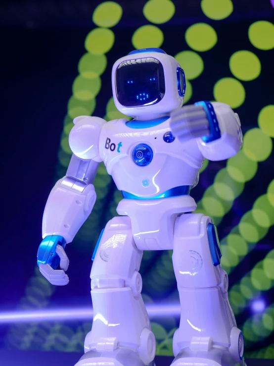 a close up of a toy robot on a table, dancing, with glowing blue lights, 4l, cybertech