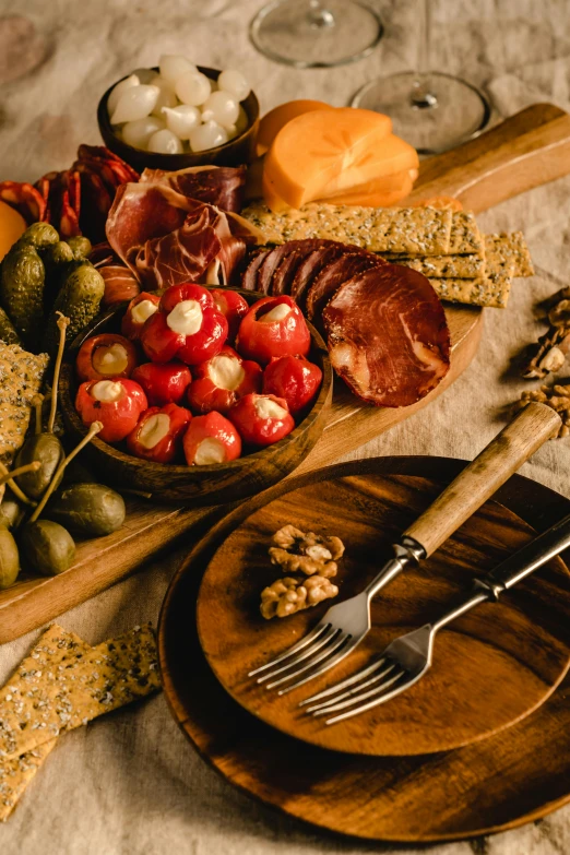 a close up of a plate of food on a table, renaissance, cheese and salami on the table, on center, curated collections, cutlery