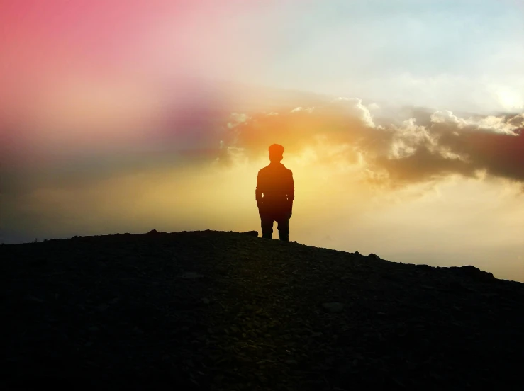 a man standing on top of a mountain at sunset, an album cover, pexels contest winner, romanticism, multicoloured, sadness, full body backlight, silhouette :7