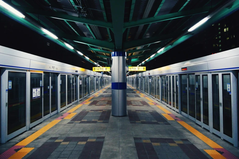 an empty platform with three doors for different train sections