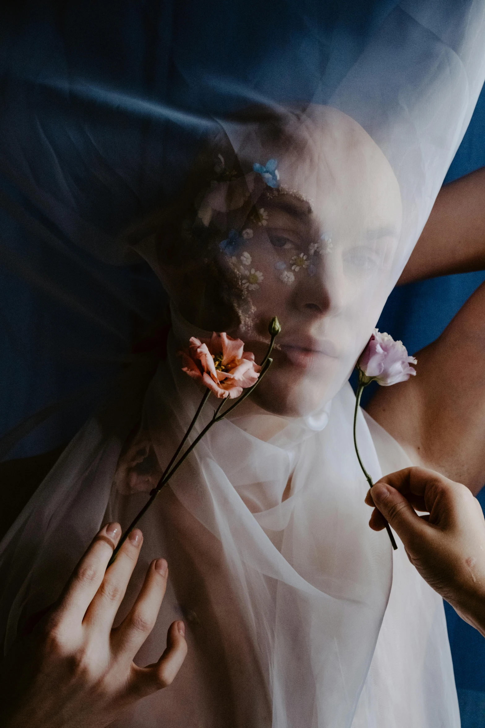 a woman holding flowers between her hands