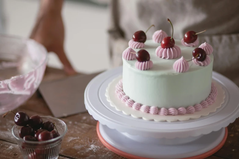 a close up of a cake on a plate on a table, a pastel, inspired by Annabel Kidston, unsplash, figuration libre, cherries, pastel green, vintage - w 1 0 2 4, blender