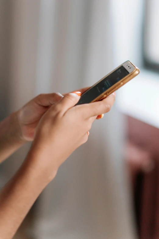 a close up of a person holding a cell phone, happening, slightly golden, at home, profile image, rectangle