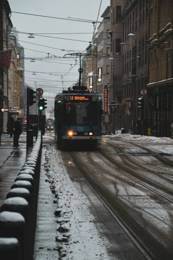 a bus driving down a snowy street next to tall buildings, by Christen Dalsgaard, pexels contest winner, helsinki, ominous mood, 🚿🗝📝, street tram