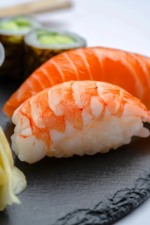 a black plate with some sushi on it