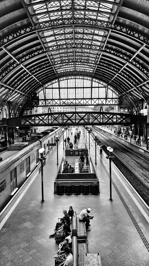 a black and white photo of a train station, inspired by Thomas Struth, pexels contest winner, square, demur, barcelona, overview