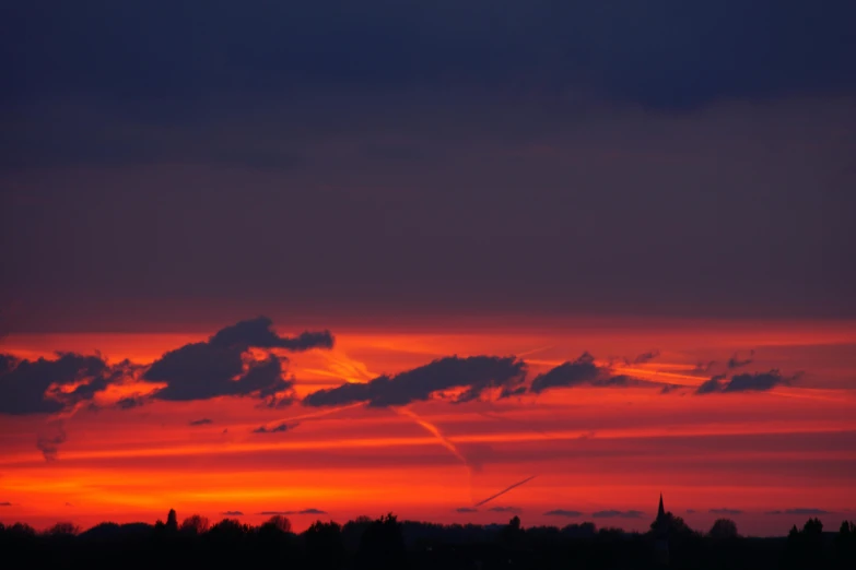 the sky is red and orange as the sun sets, by Jan Tengnagel, pexels contest winner, hannover, red and blue