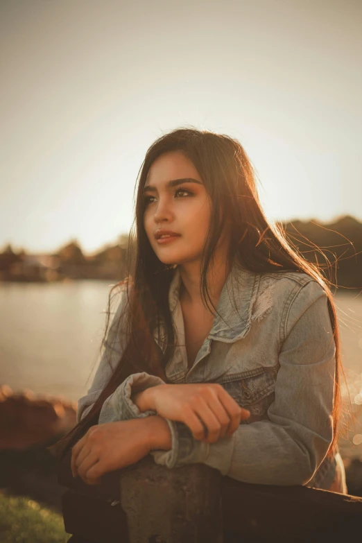 a young woman poses with her hair blowing in the wind