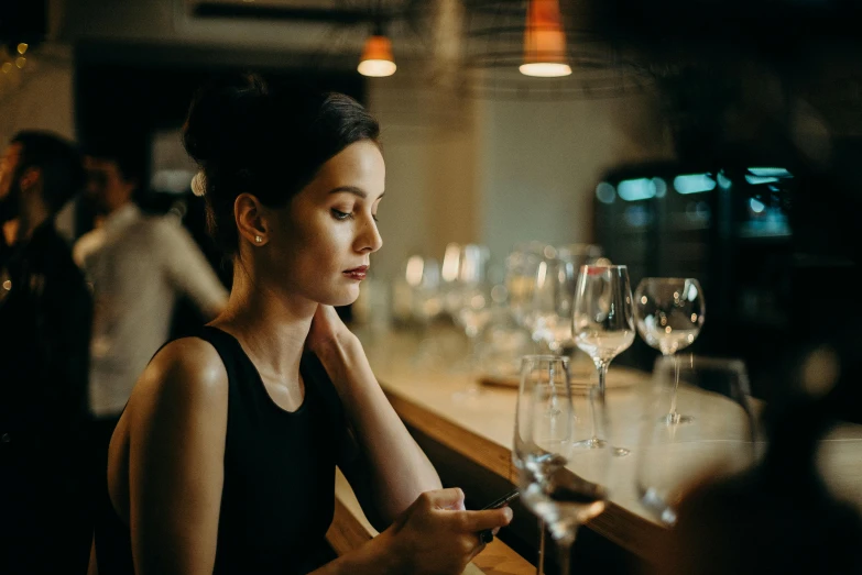 a woman sitting at a bar looking at her cell phone, pexels contest winner, renaissance, scene from a dinner party, thoughtful ), slightly minimal, sydney hanson