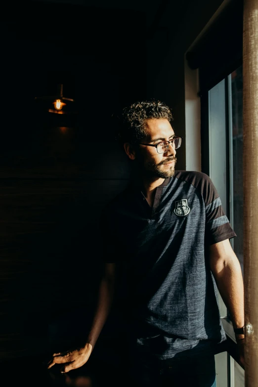 man standing in corner of window looking in