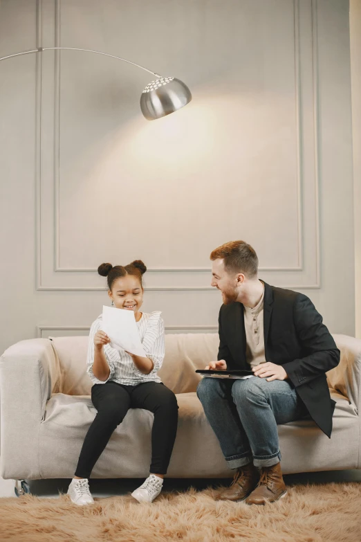 a man and a woman sitting on a couch, by Adam Marczyński, pexels contest winner, little girl, in a meeting room, tyler edlin and natasha tan, gif