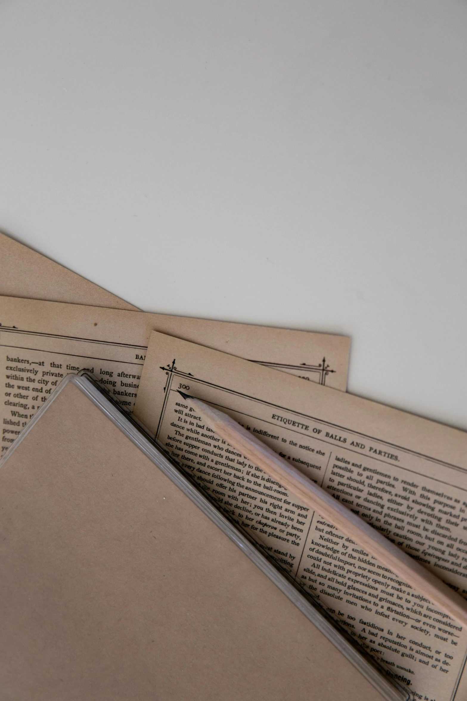 a pile of books sitting on top of a table, on vellum, detailed product image, early 1900s newspaper, detail shots