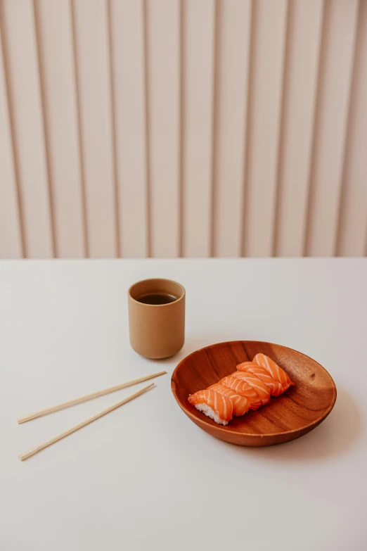 two fish are on the table with chop sticks in front of it