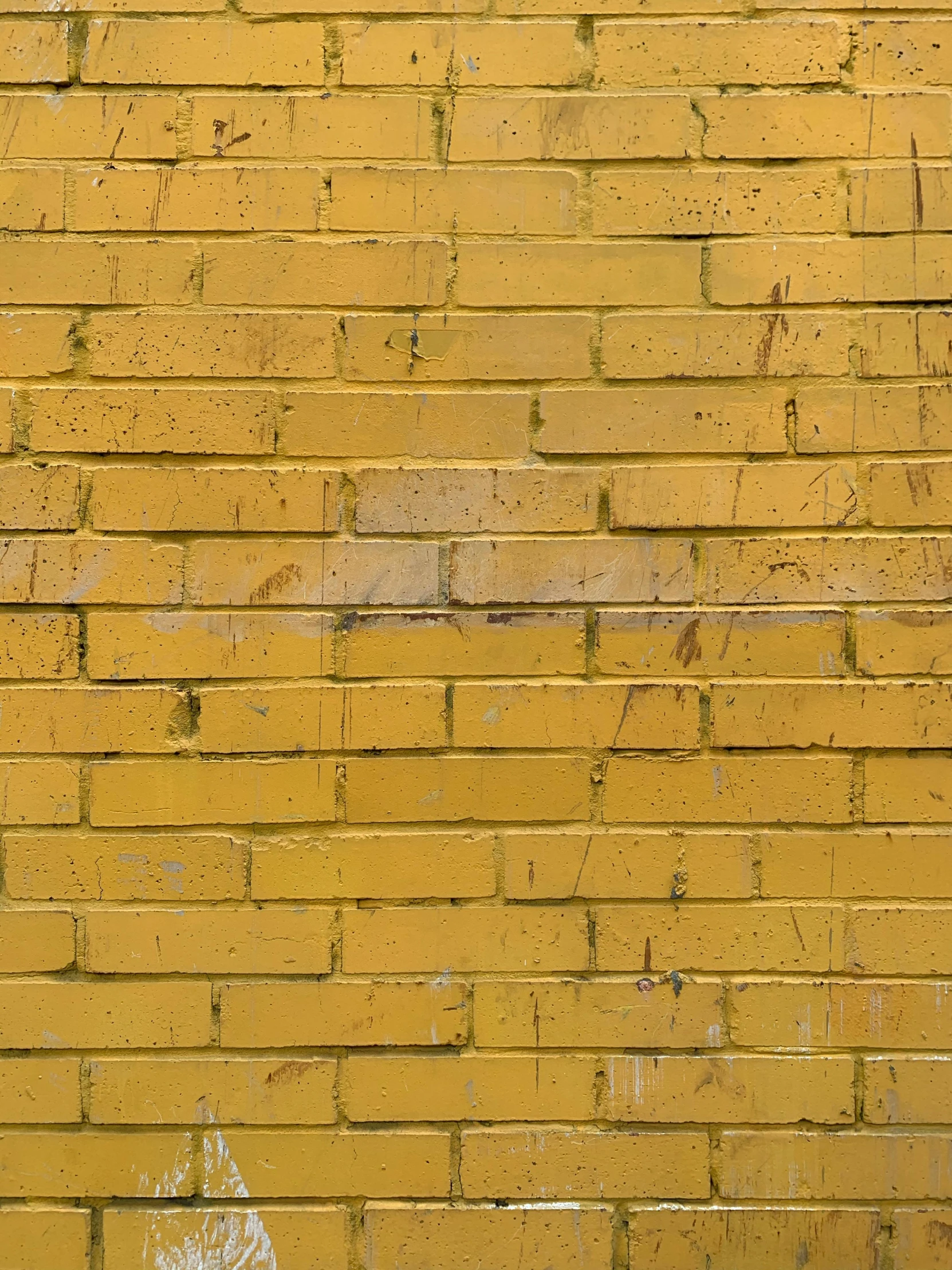 a fire hydrant on the side of a brick wall