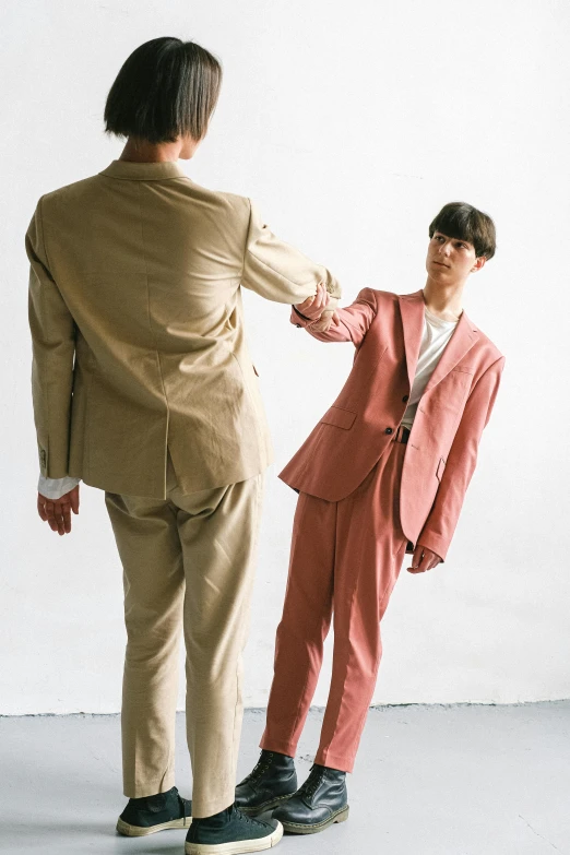 two men in suits looking at each other