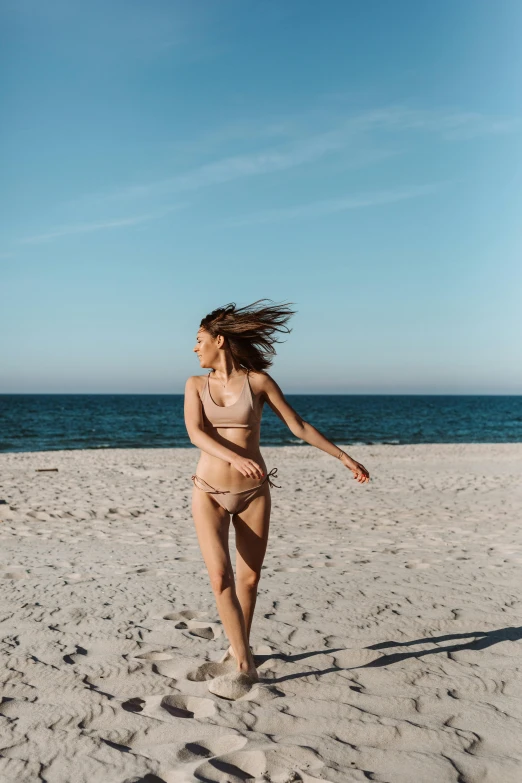 a woman in a bikini running on a beach, pexels contest winner, minimalism, hair waving in the wind, brown, gif, denim