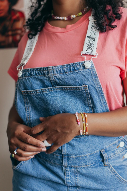 a woman is wearing blue jeans and an orange shirt