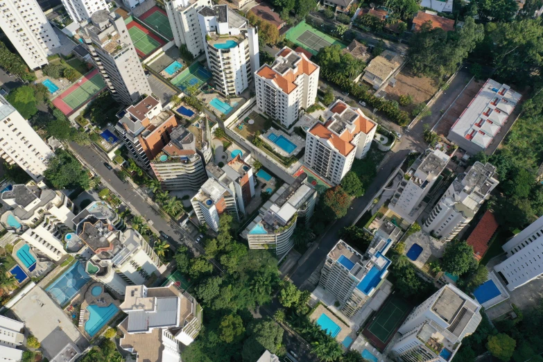 an aerial view of a city with lots of buildings, by Felipe Seade, unsplash, photorealism, alvaro siza, outdoors tropical cityscape, concrete housing, 2000s photo