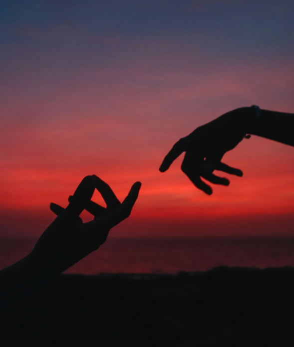 two hands reaching for each other in front of a sunset, by Alexis Grimou, pexels, 🪔 🎨;🌞🌄, red hues, calmly conversing 8k, photograph taken in 2 0 2 0