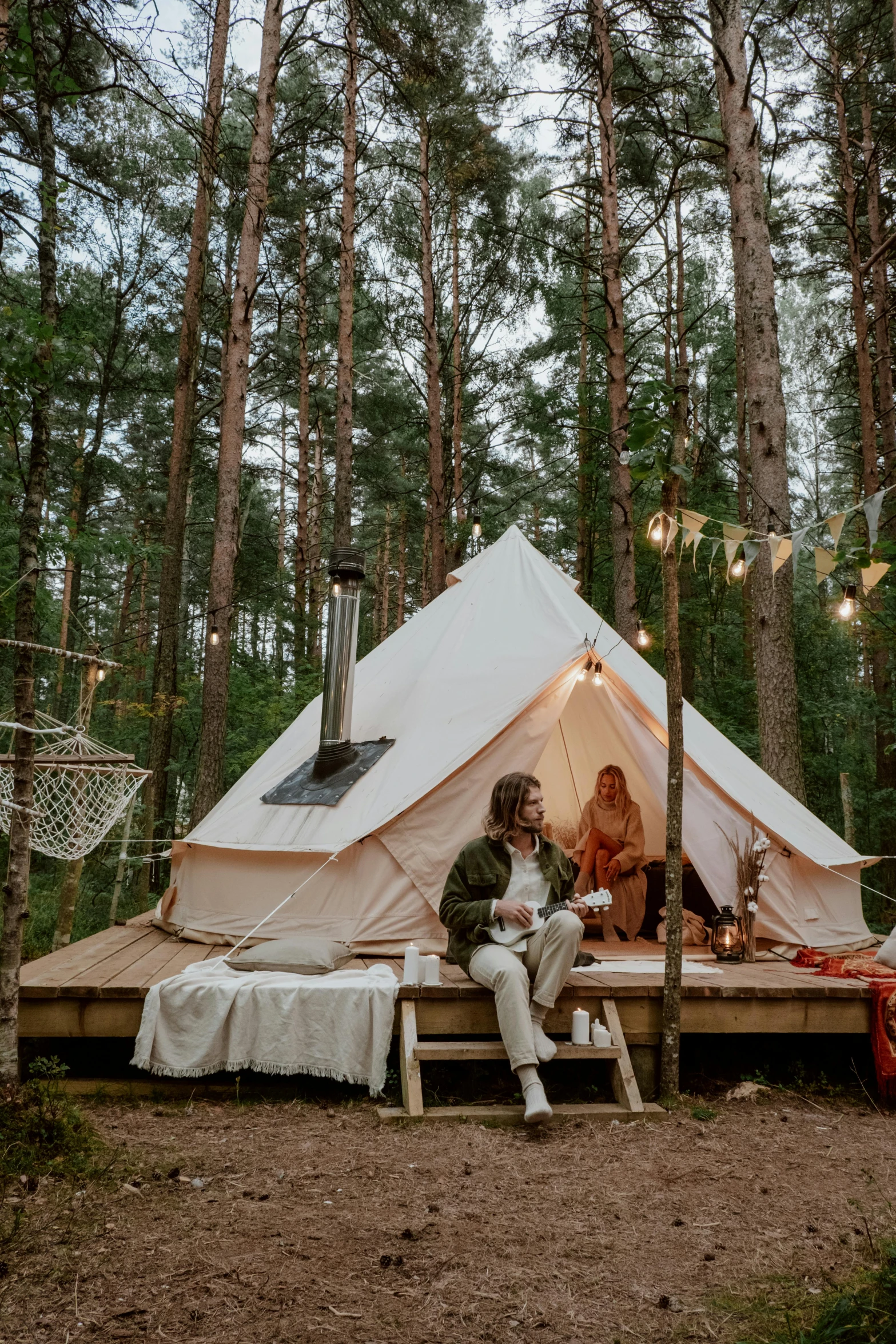 two people sitting outside of a tent in the woods, luxurious environment, bright nordic forest, - 9, bells