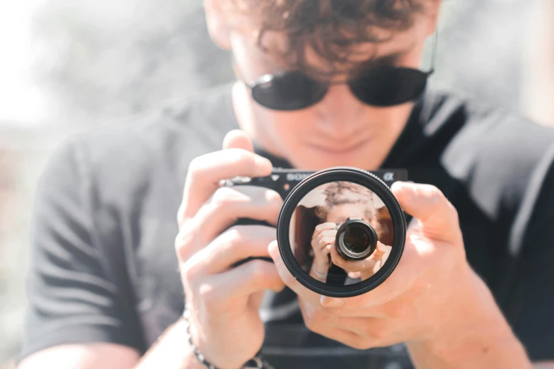 a man taking a picture with a camera, a picture, by Joe Bowler, pexels contest winner, zoomed in shots, magnified, title, looking up at the camera