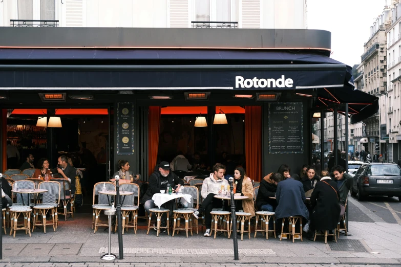 a group of people sitting at tables outside of a restaurant, by Richmond Barthé, ratatouille style, rondel, octane remder, shop front