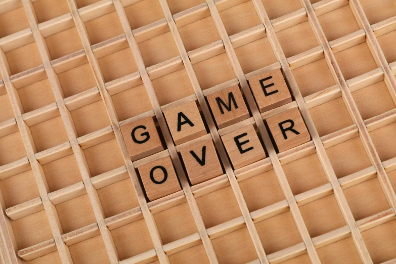 a close up of a wooden box with letters on it, an album cover, by Joe Bowler, shutterstock, excessivism, game board, when it's over, injured, the end