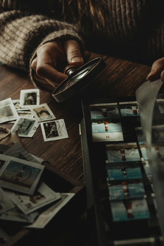 some cards on a table and someone holding a camera