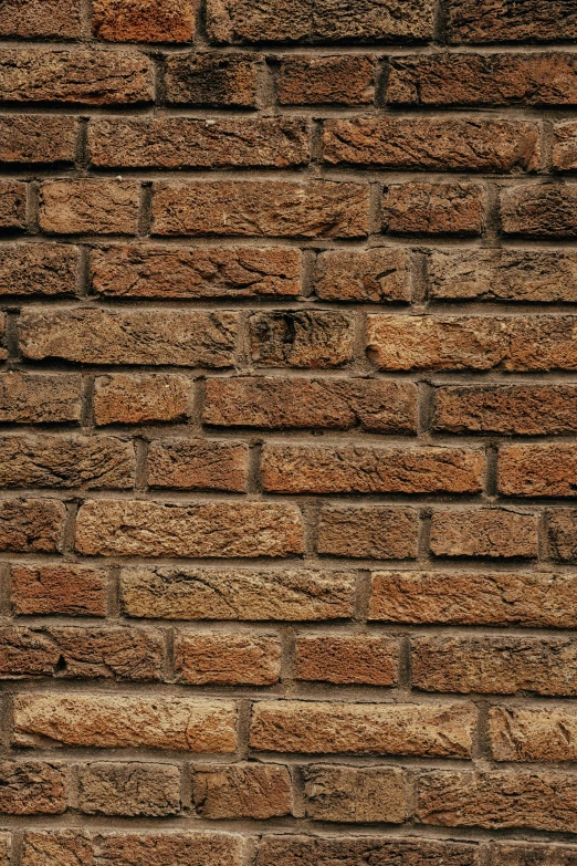 a red stop sign sitting on the side of a brick building