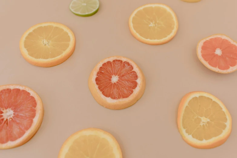 a table topped with slices of grapefruit and lime, trending on pexels, photorealism, background image, minimalist photo, candy decorations, miniature product photo