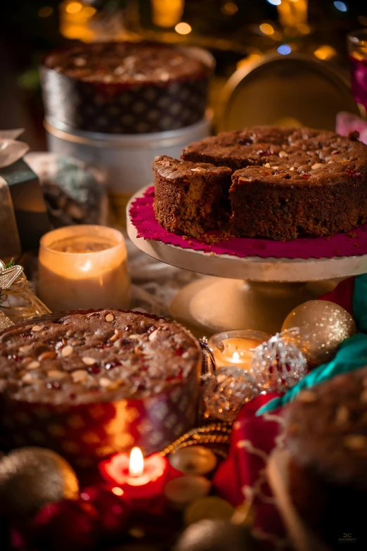 a table topped with cakes and candles on top of a table, by Lucette Barker, festive atmosphere, product shot, chocolate, gifts