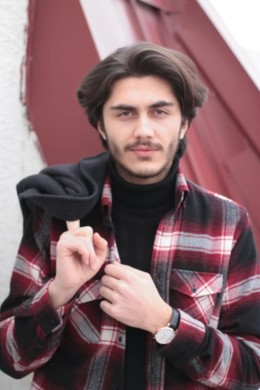 a man that is looking up with a watch on his wrist