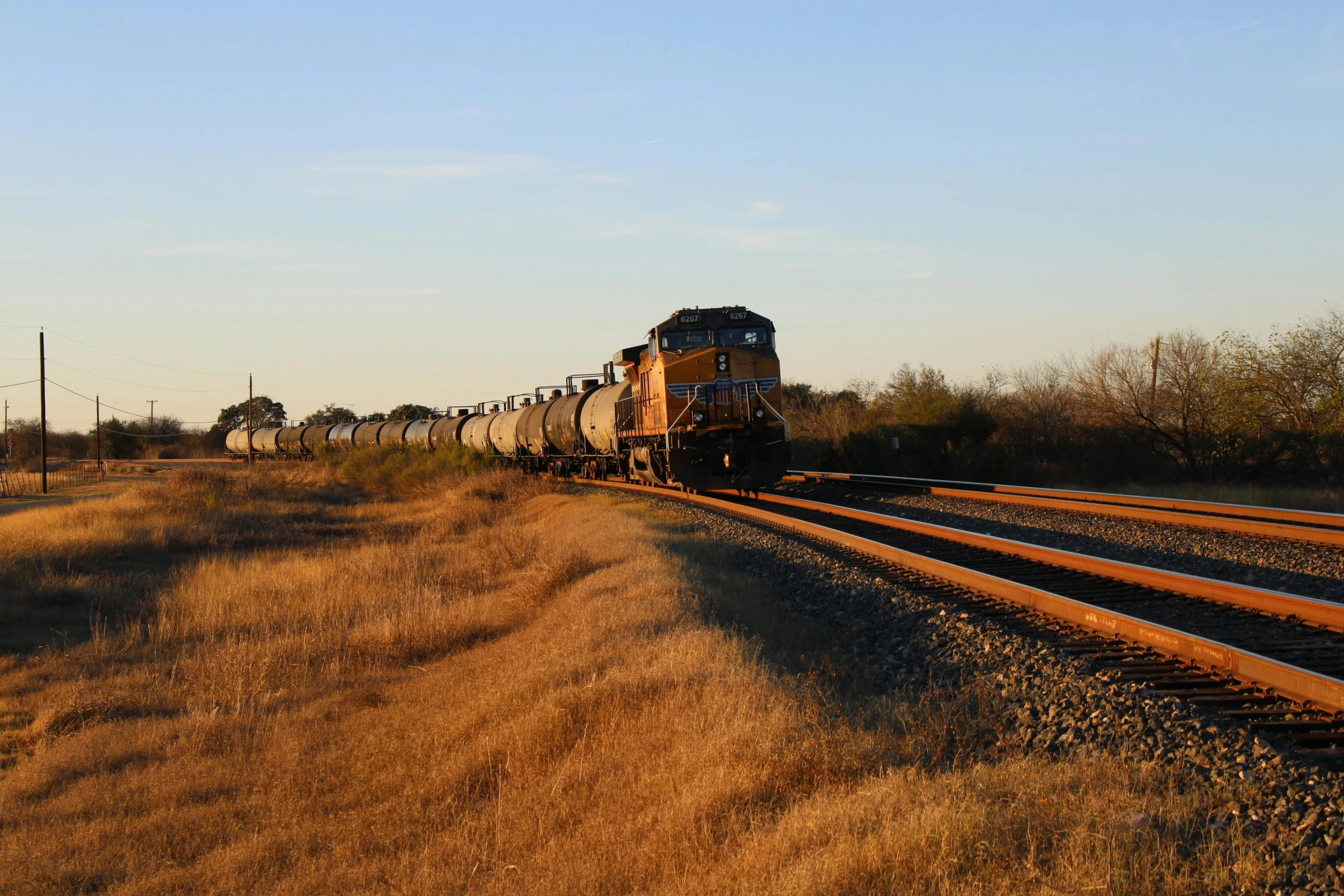 a large long train on a steel track, by Everett Warner, unsplash, tx, profile image, low quality photo, thumbnail