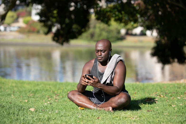 a man kneeling down holding a cell phone