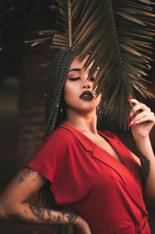 a woman in a red dress smoking a cigarette, inspired by Elsa Bleda, trending on pexels, with palm trees in the back, black young woman, sexy lips :5 stylish, with black vines