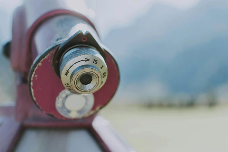 a close up of a telescope with mountains in the background, pexels contest winner, visual art, hasselblad film bokeh, macro 8 mm, vintage color, metal eye piece