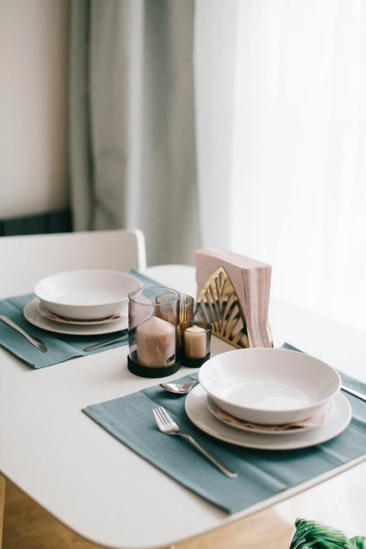 plates and napkins sitting on top of a white table